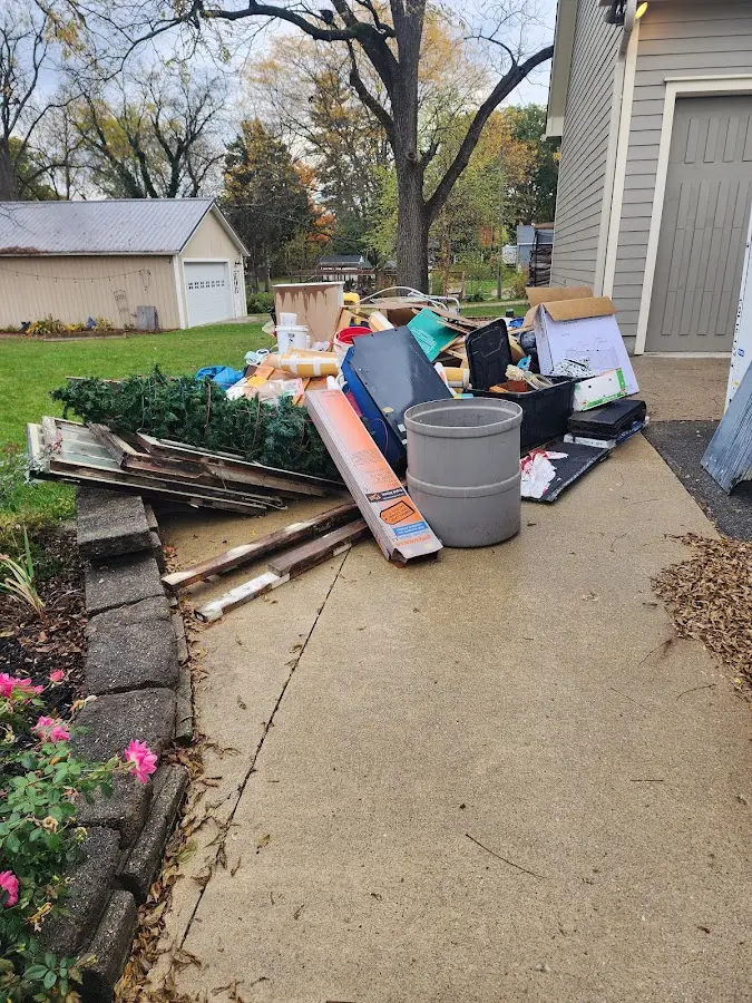Dumpster being loaded with debris for Commercial Dumpster Rental in Fort Gratiot